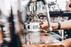 Espresso machine pouring coffee into cup